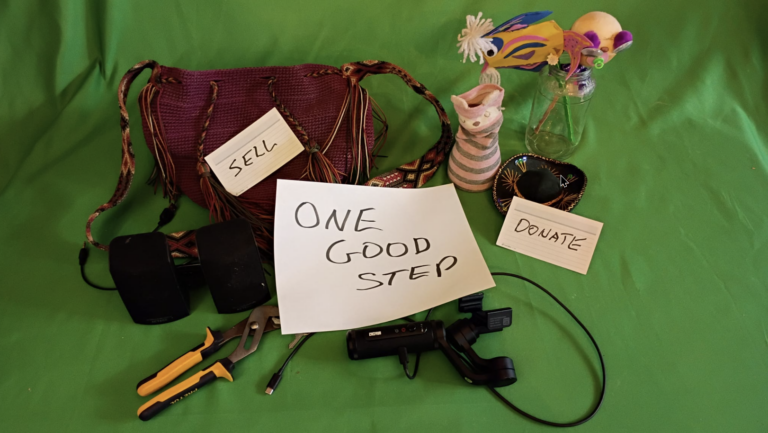 Items staged for downsizing with note cards: Sell, Donate, Take one good step